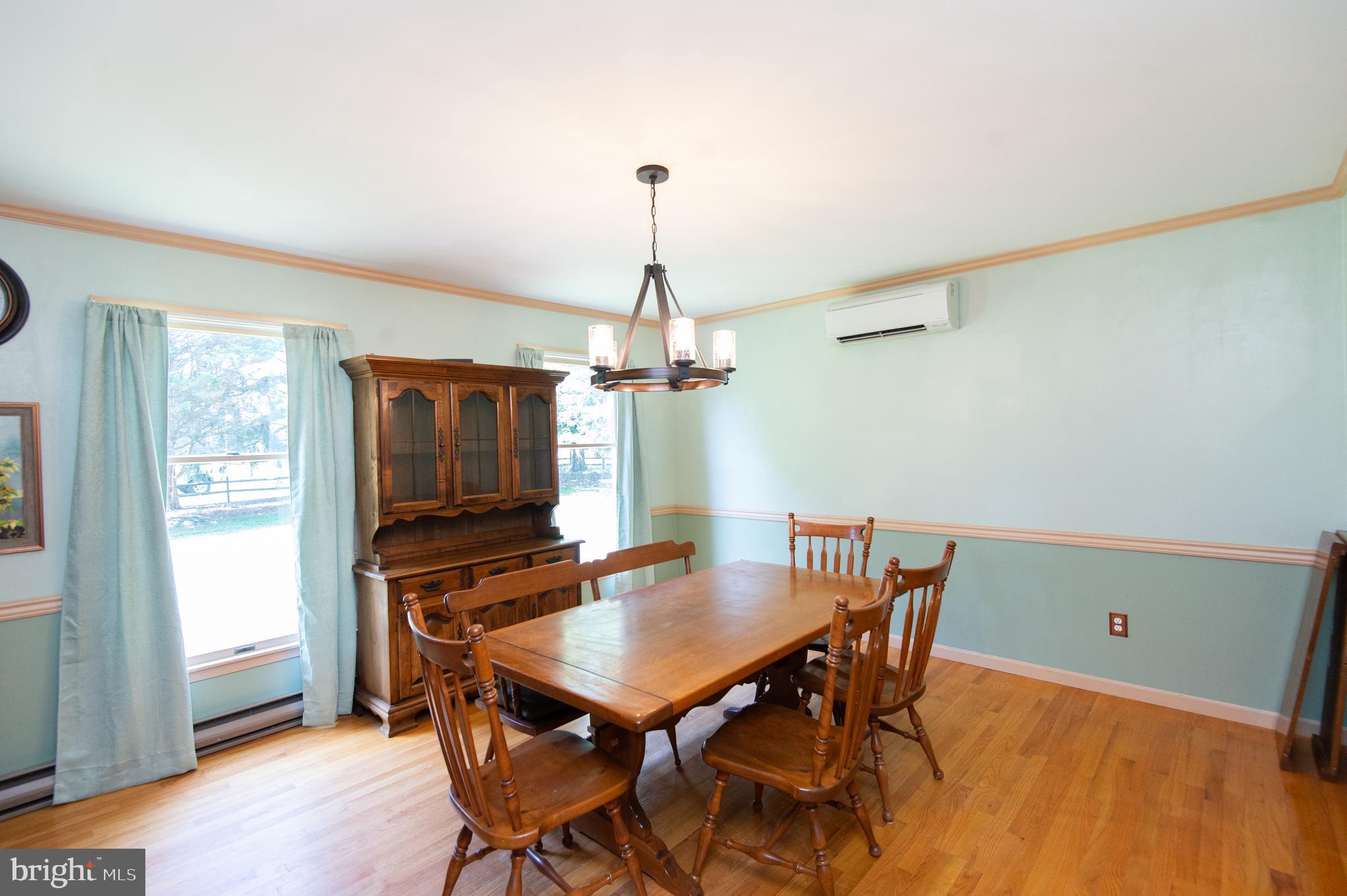 9472 Quail Run Road Denton, MD 21629 - Photo 7 of 50 a view of a dining room with furniture and wooden floor