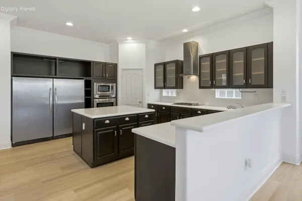 a kitchen with stainless steel appliances a sink and a refrigerator