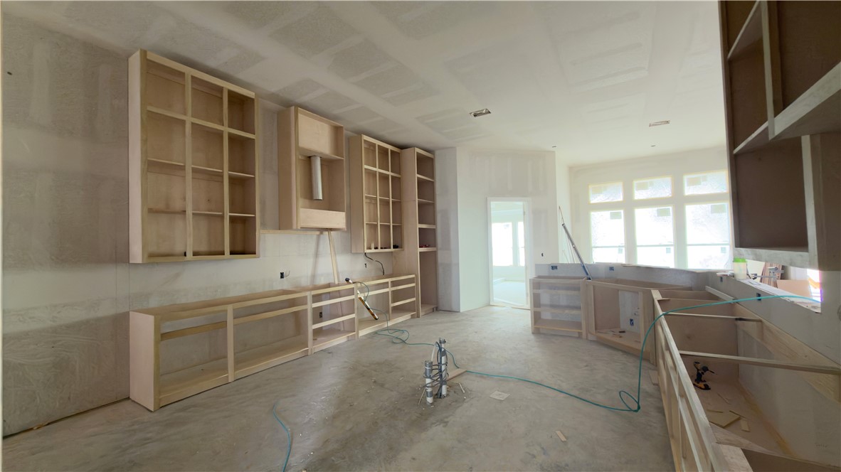 2602 Atlantic View Street Corpus Christi, TX 78415 - Photo 2 of 14 a large kitchen with kitchen island a sink a counter space and a window