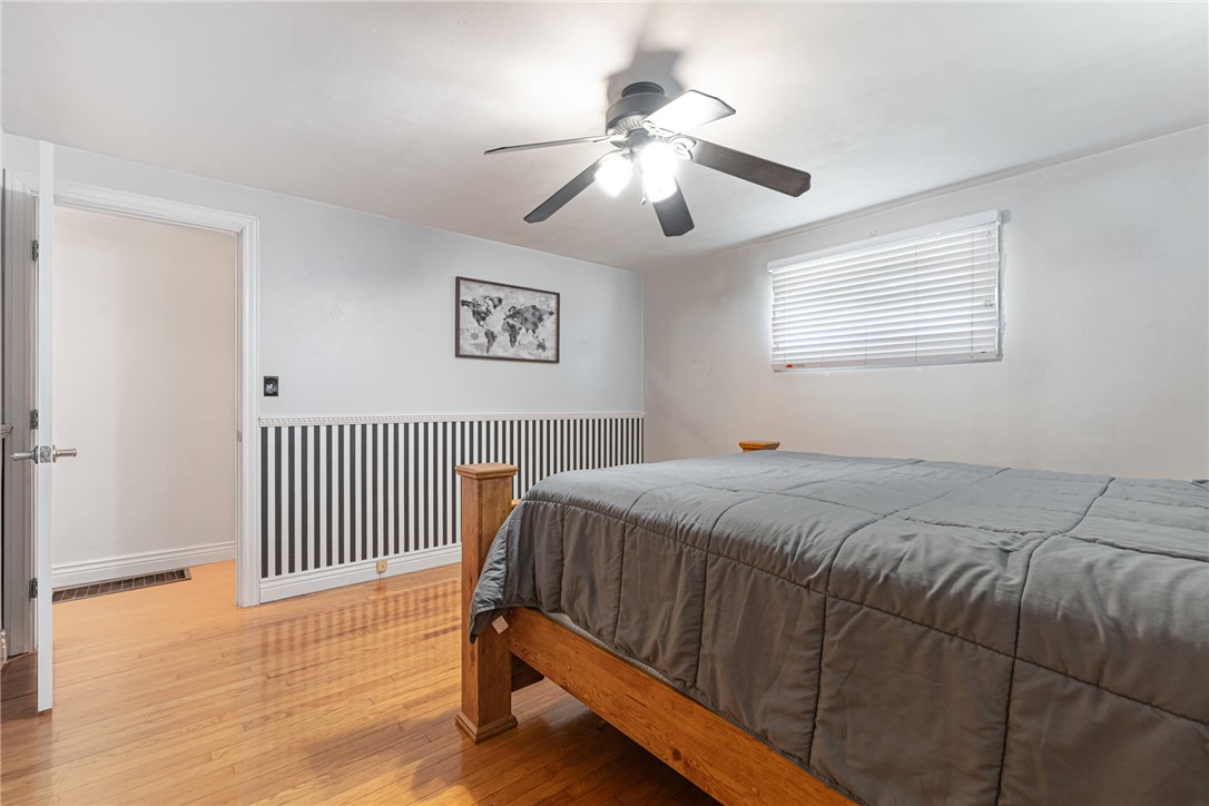 5235 West Ridgewood Road Springfield, OH 45503 - Photo 16 of 32 This spacious bedroom features lustrous hardwood flooring and an inviting ceiling fan for comfort.