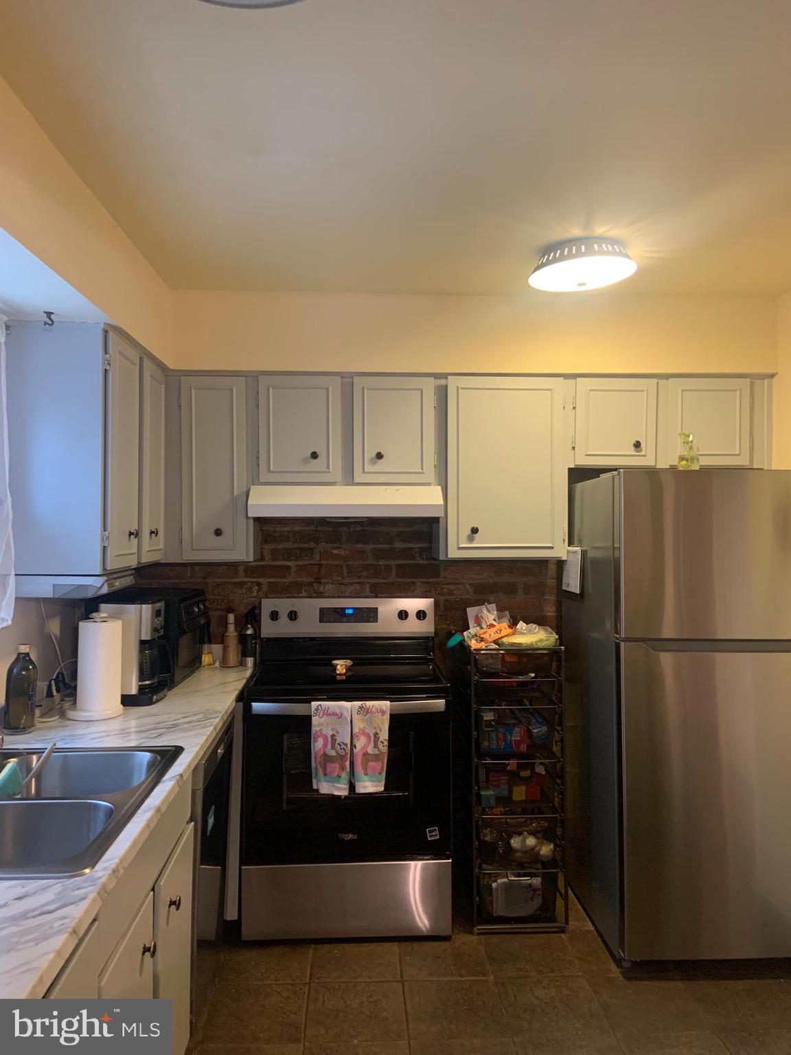 8210 Carrleigh Parkway, Unit 6 Springfield, VA 22152 - Photo 12 of 32 a kitchen with a stove and a refrigerator