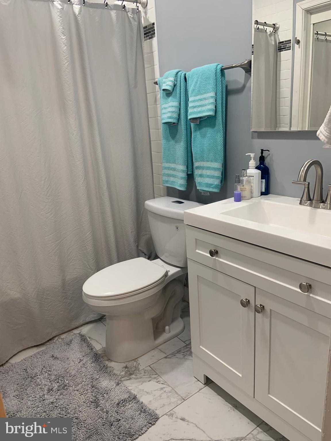 8210 Carrleigh Parkway, Unit 6 Springfield, VA 22152 - Photo 23 of 32 a bathroom with a toilet sink and shower