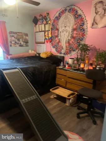 a bedroom with a bed next to a window