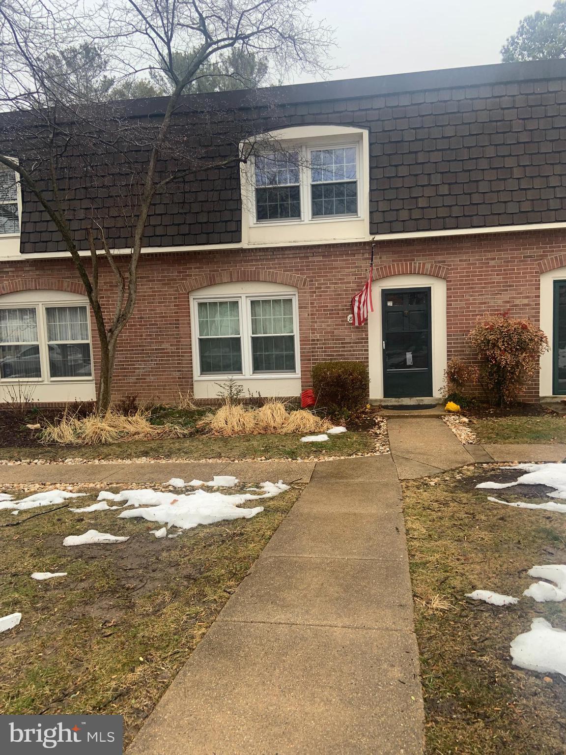 8210 Carrleigh Parkway, Unit 6 Springfield, VA 22152 - Photo 30 of 32 a front view of a house with a yard