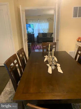 a table with chairs and a lamp on table
