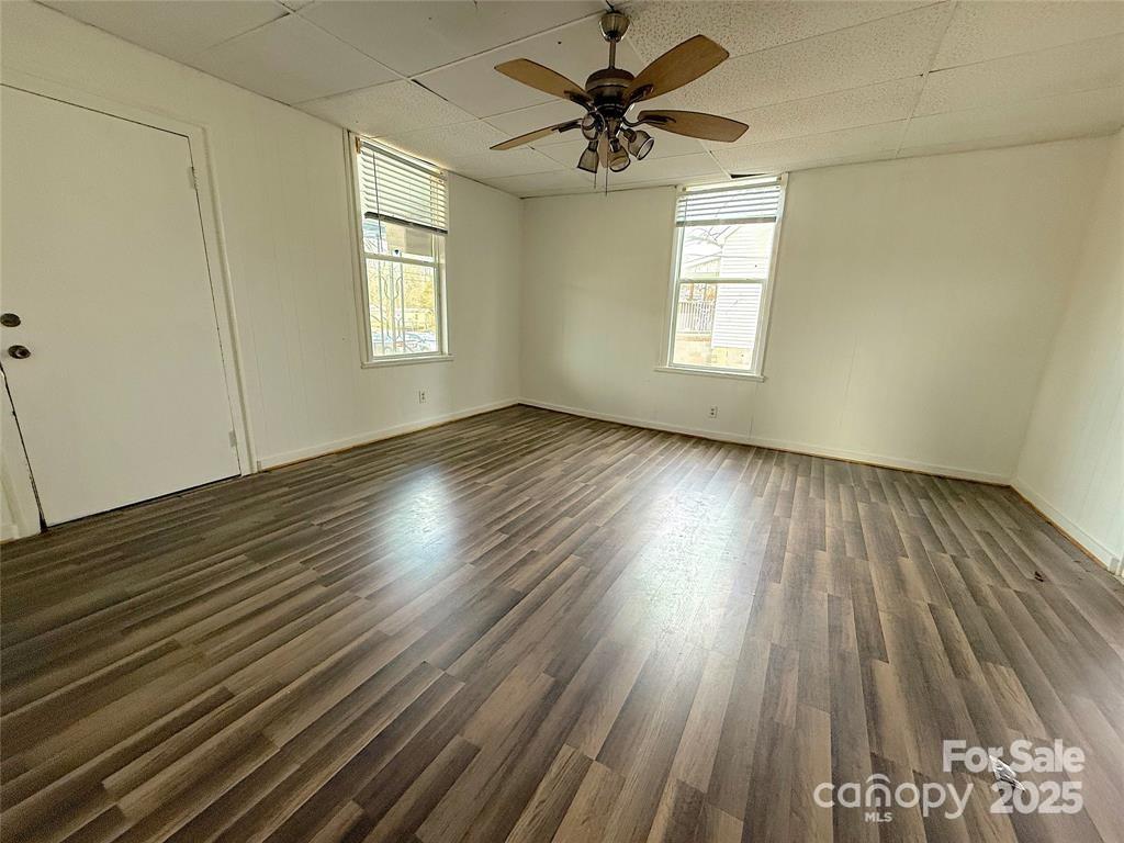 309 Spring Street Union, SC 29379 - Photo 3 of 11 wooden floor in an empty room with a window