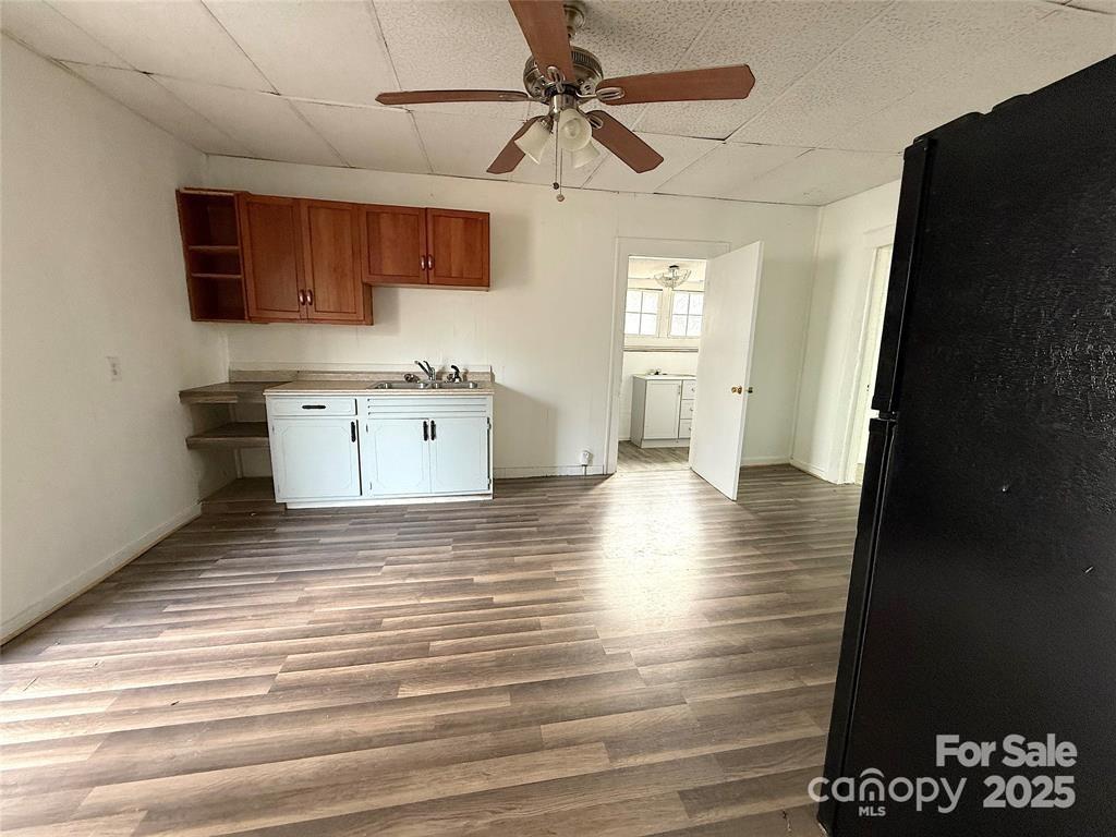 309 Spring Street Union, SC 29379 - Photo 6 of 11 a view of a kitchen with a sink dishwasher a refrigerator with wooden floor