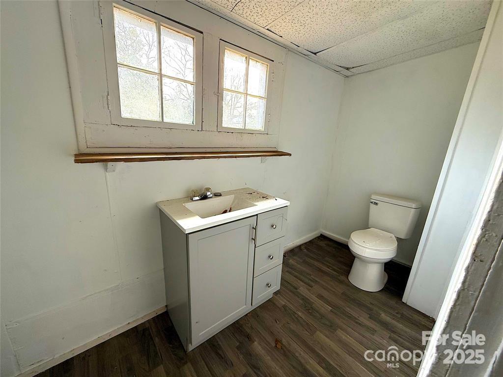 309 Spring Street Union, SC 29379 - Photo 7 of 11 a bathroom with a toilet a sink and a window