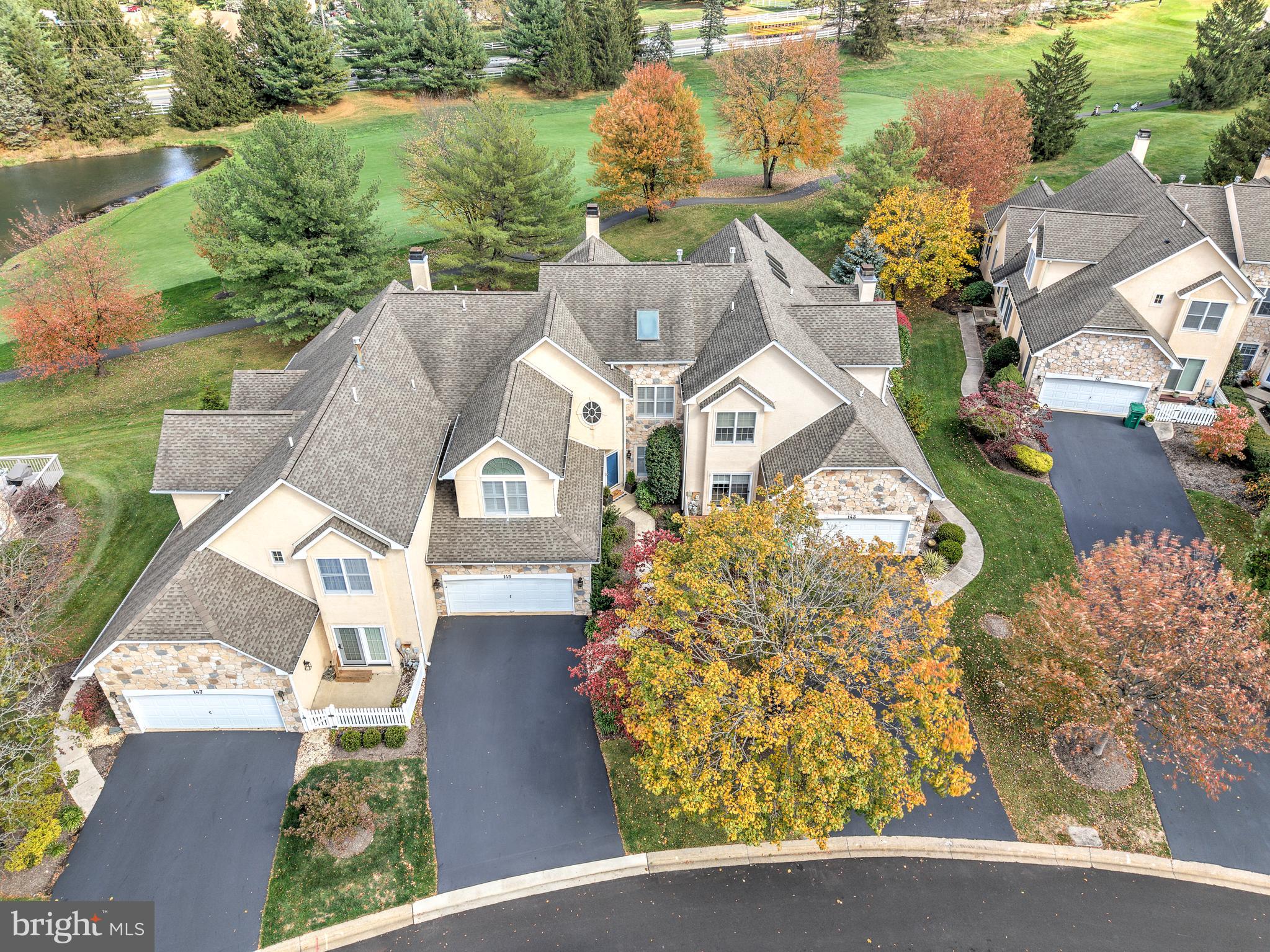 145 Sawgrass Drive Blue Bell, PA 19422 - Photo 1 of 61 an aerial view of a house with a garden and lake view