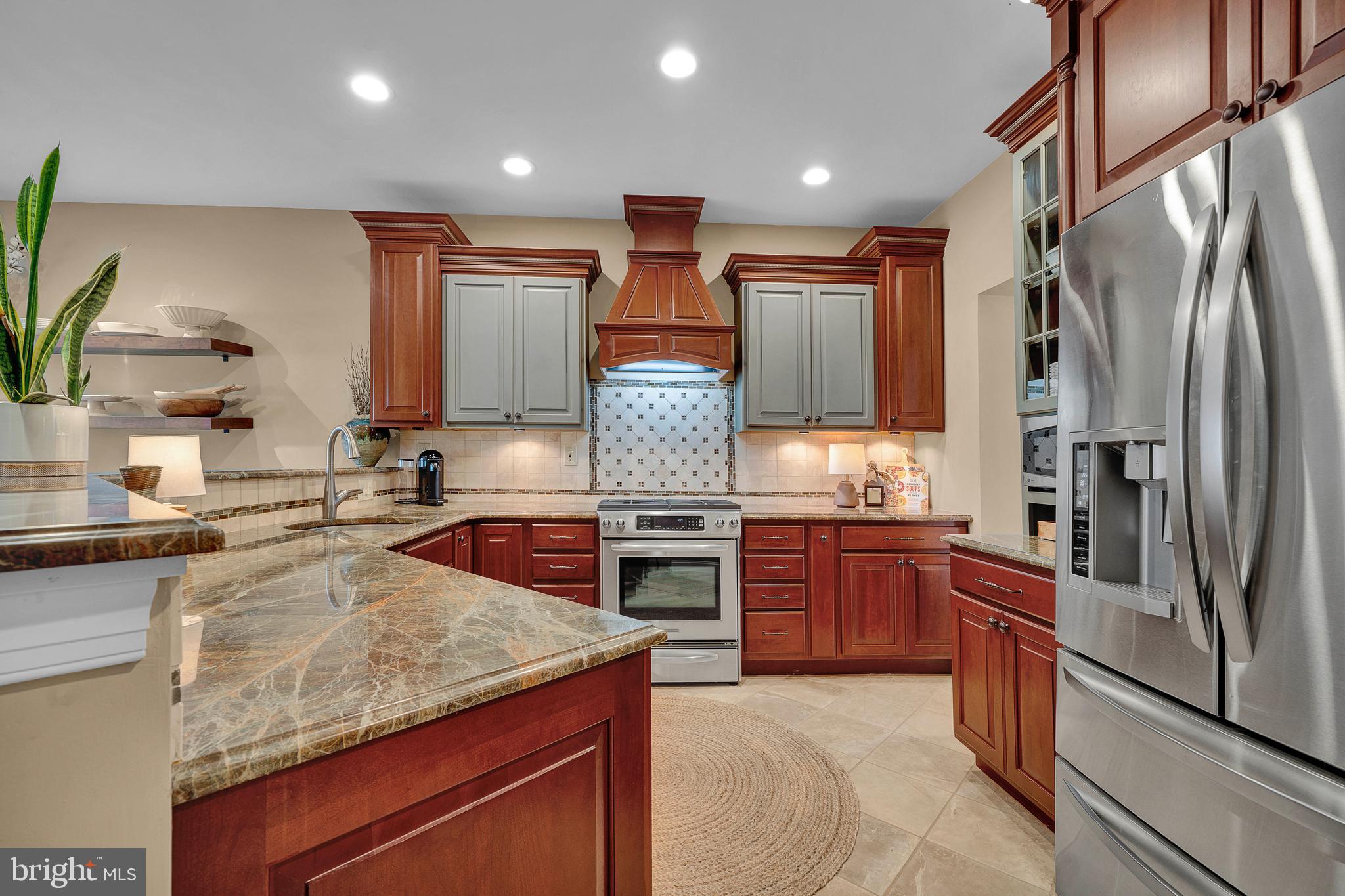 145 Sawgrass Drive Blue Bell, PA 19422 - Photo 16 of 61 a kitchen with stainless steel appliances granite countertop a sink stove and refrigerator