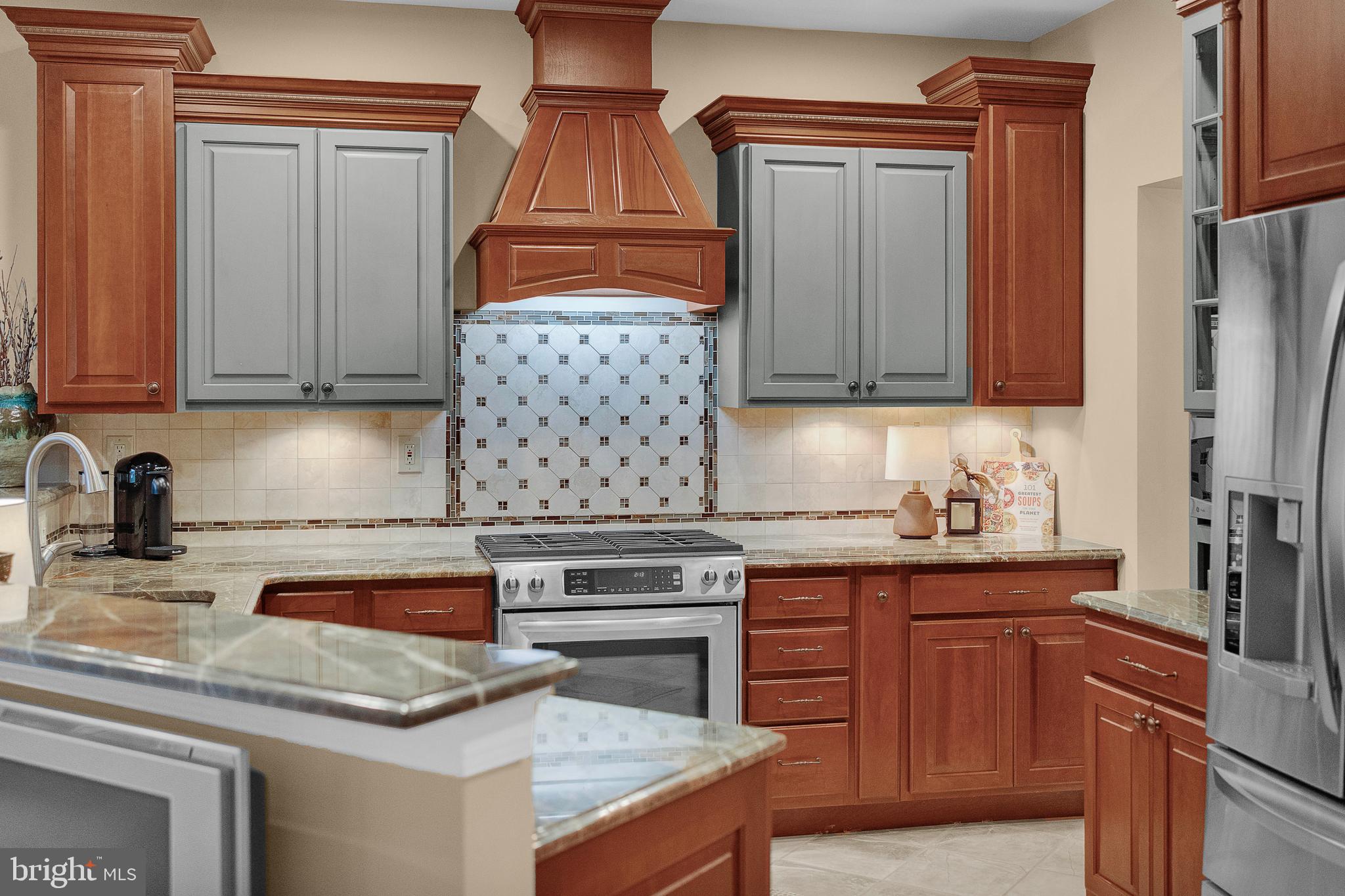 145 Sawgrass Drive Blue Bell, PA 19422 - Photo 17 of 61 a kitchen with stainless steel appliances granite countertop a sink stove and refrigerator