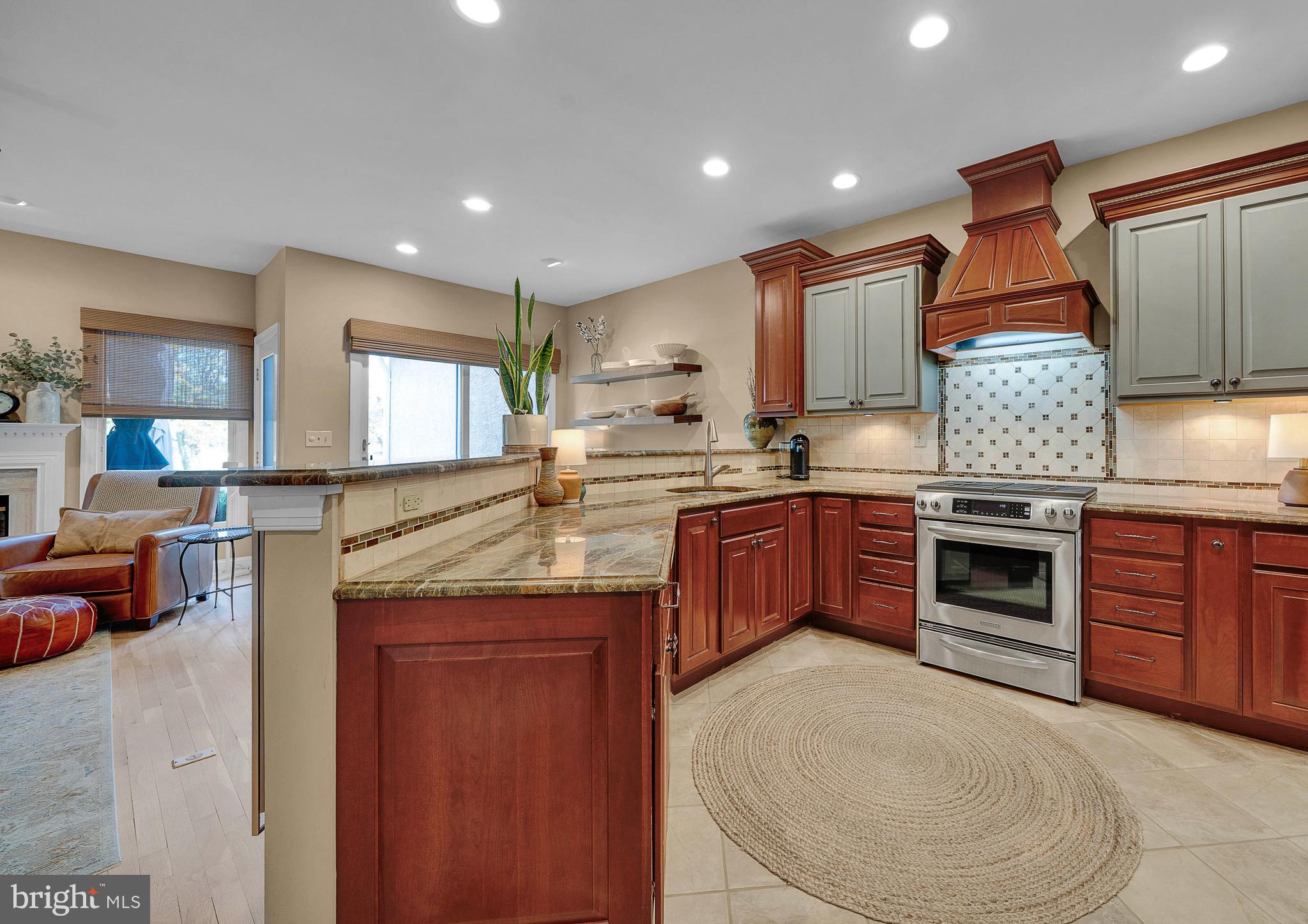 145 Sawgrass Drive Blue Bell, PA 19422 - Photo 18 of 61 a kitchen with stainless steel appliances granite countertop a stove sink and cabinets