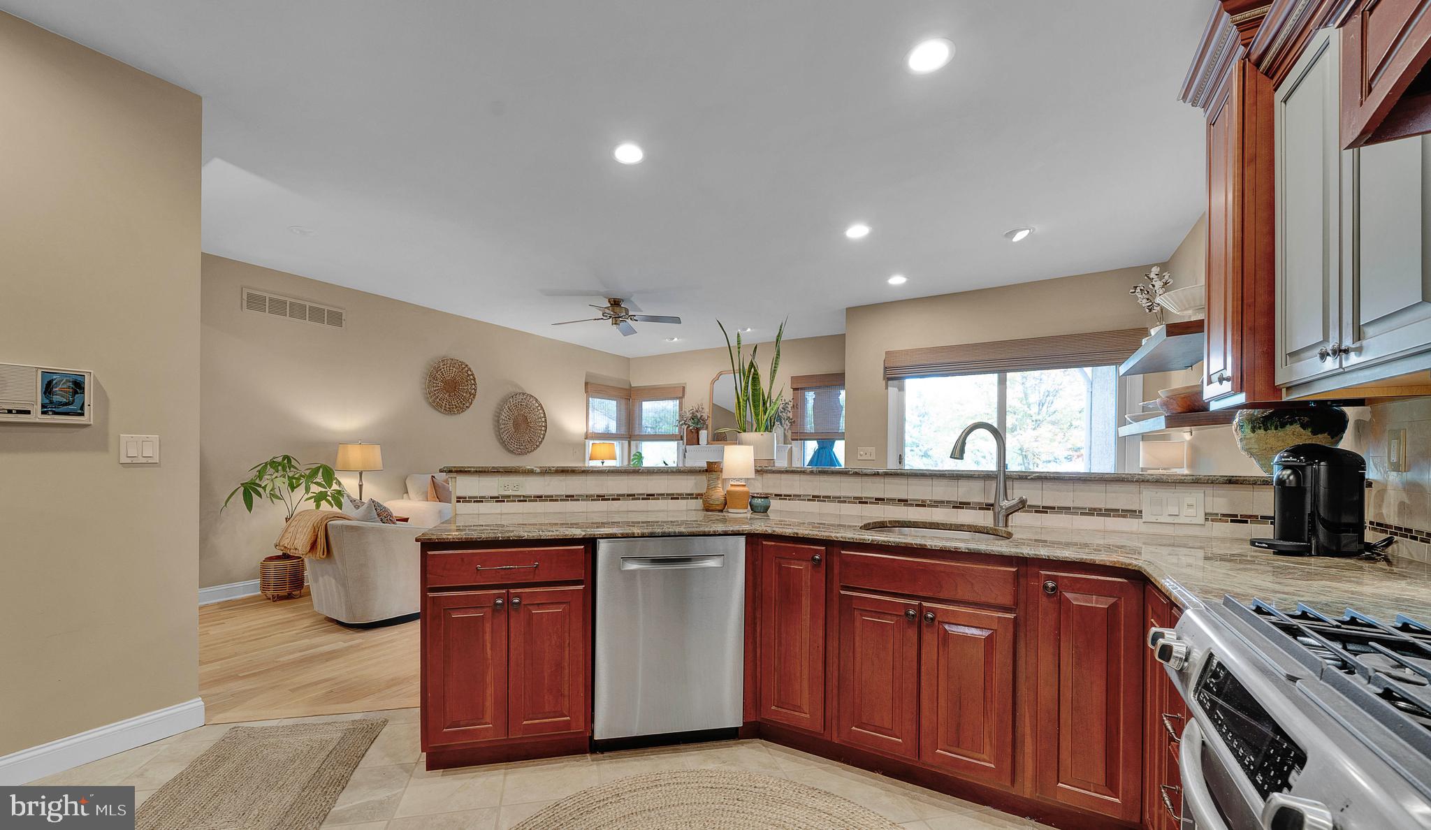 145 Sawgrass Drive Blue Bell, PA 19422 - Photo 19 of 61 a kitchen with a sink stove and wooden cabinets