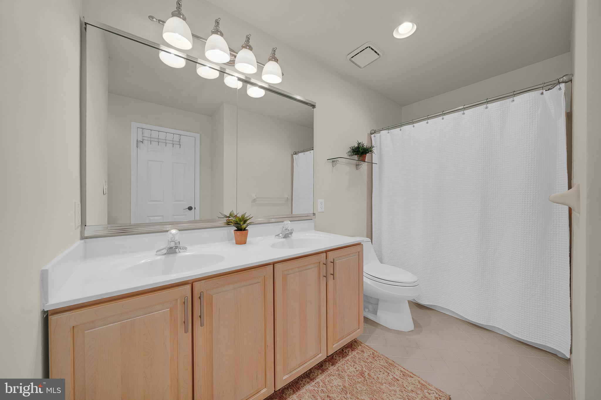 145 Sawgrass Drive Blue Bell, PA 19422 - Photo 32 of 61 a bathroom with a double vanity sink mirror and toilet