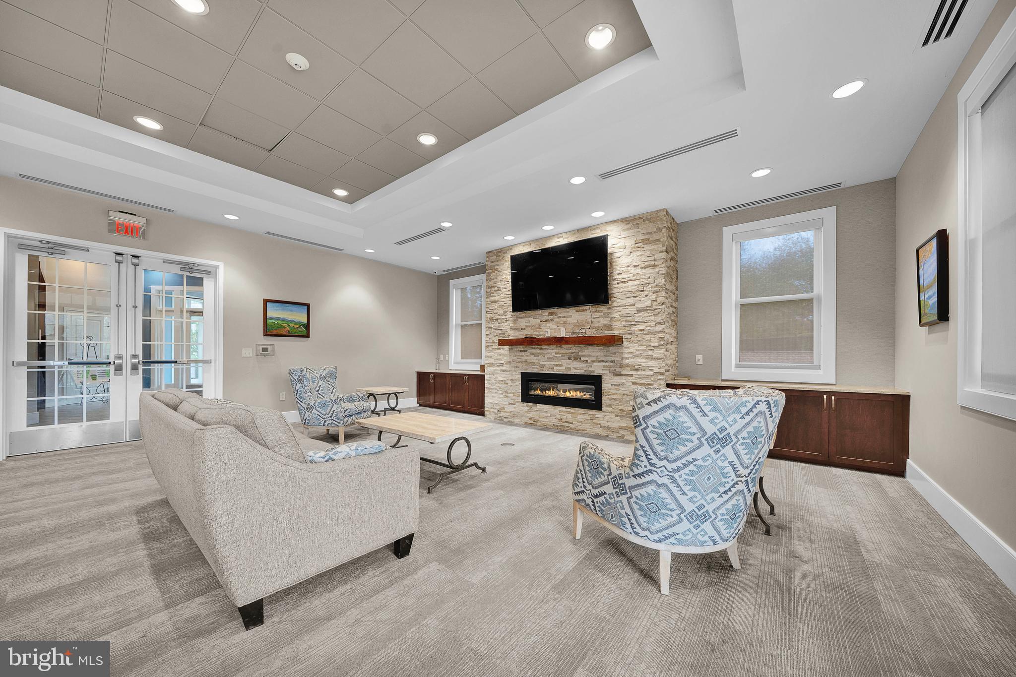 145 Sawgrass Drive Blue Bell, PA 19422 - Photo 51 of 61 a living room with furniture a fireplace and a flat screen tv