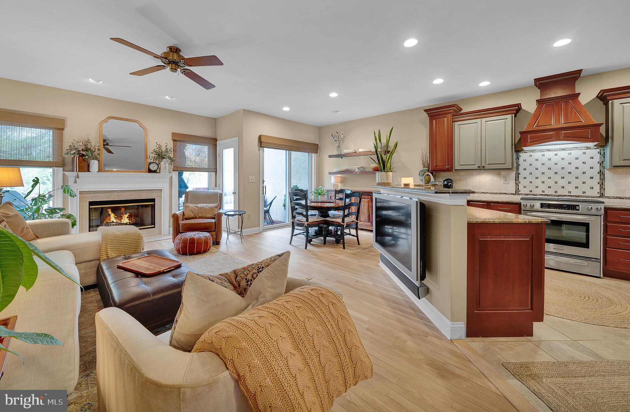 145 Sawgrass Drive Blue Bell, PA 19422 - Photo 10 of 61 a living room with furniture a fireplace and a kitchen