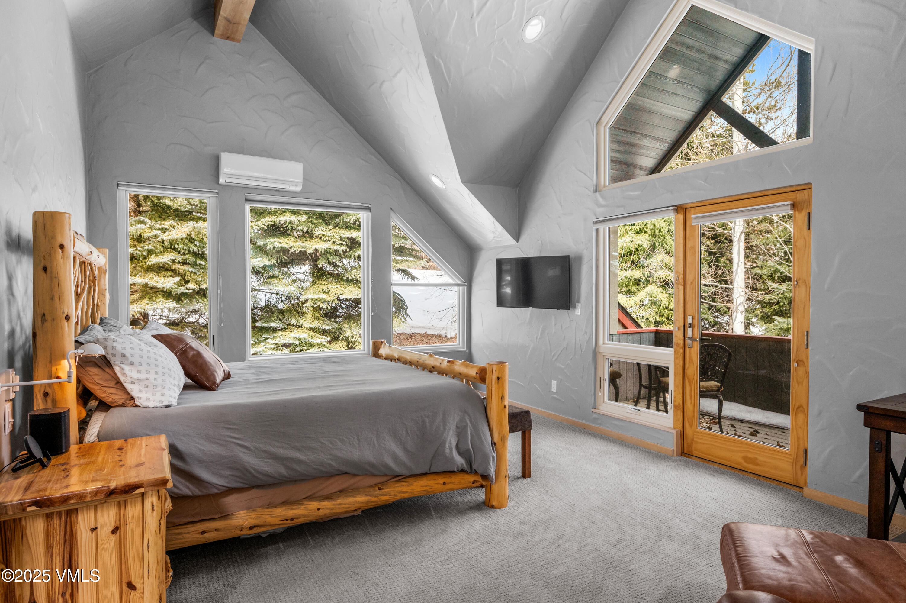 2349 Chamonix Lane Vail, CO 81657 - Photo 14 of 43 a bedroom with a bed and wooden floor