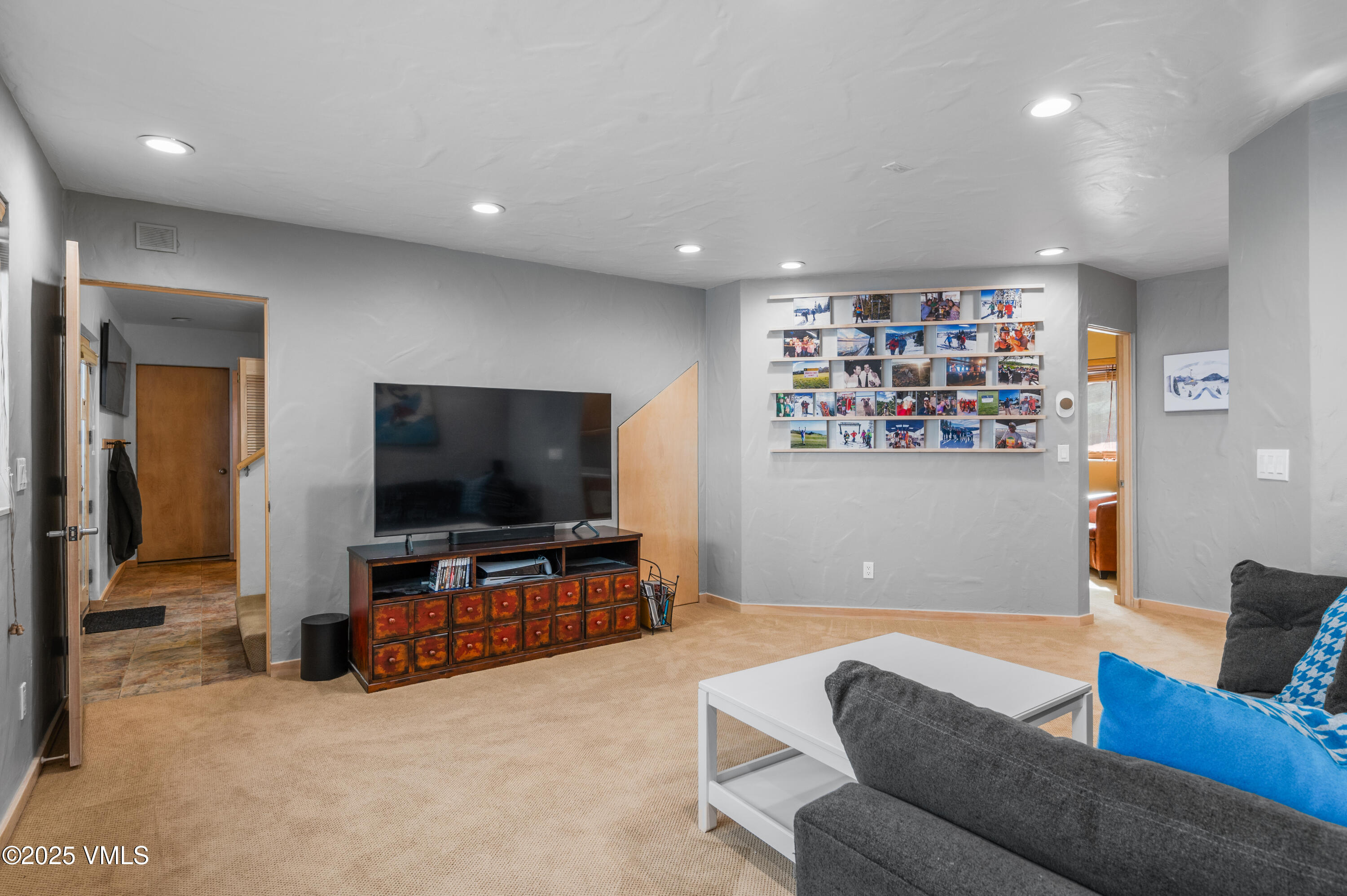 2349 Chamonix Lane Vail, CO 81657 - Photo 22 of 43 a living room with furniture and a flat screen tv