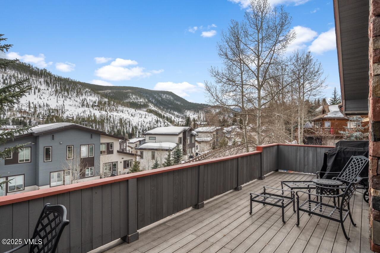 2349 Chamonix Lane Vail, CO 81657 - Photo 37 of 43 a view of a balcony with furniture and wooden floor