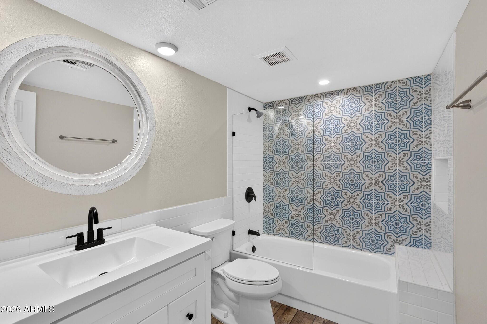4615 East Monte Way Phoenix, AZ 85044 - Photo 12 of 35 a bathroom with a sink a toilet and a mirror