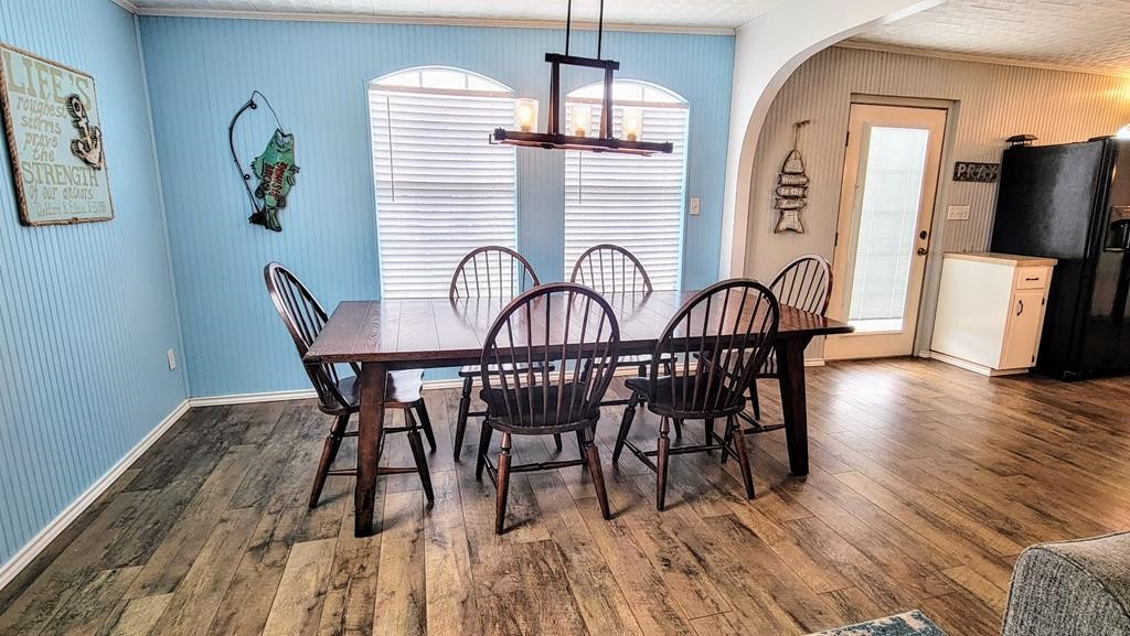 619 Copano Cove Road Rockport, TX 78382 - Photo 12 of 32 a view of a dining room with furniture window and wooden floor