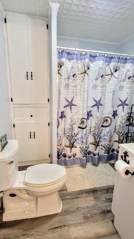 619 Copano Cove Road Rockport, TX 78382 - Photo 16 of 32 a white toilet sitting next to a shower curtain