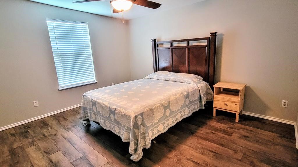 619 Copano Cove Road Rockport, TX 78382 - Photo 20 of 32 a bedroom with a bed and a window