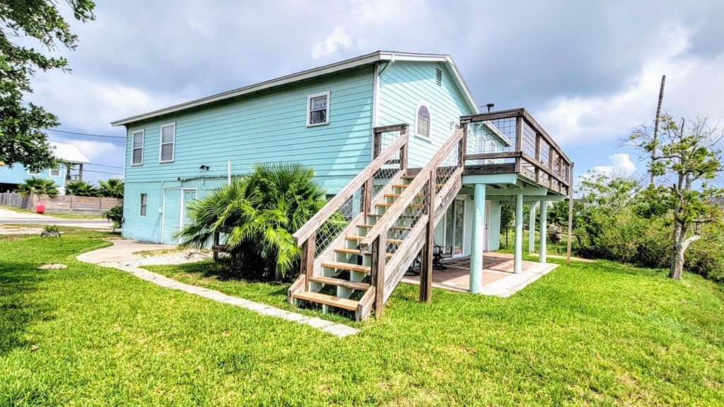 619 Copano Cove Road Rockport, TX 78382 - Photo 2 of 32 a view of a house with backyard and deck