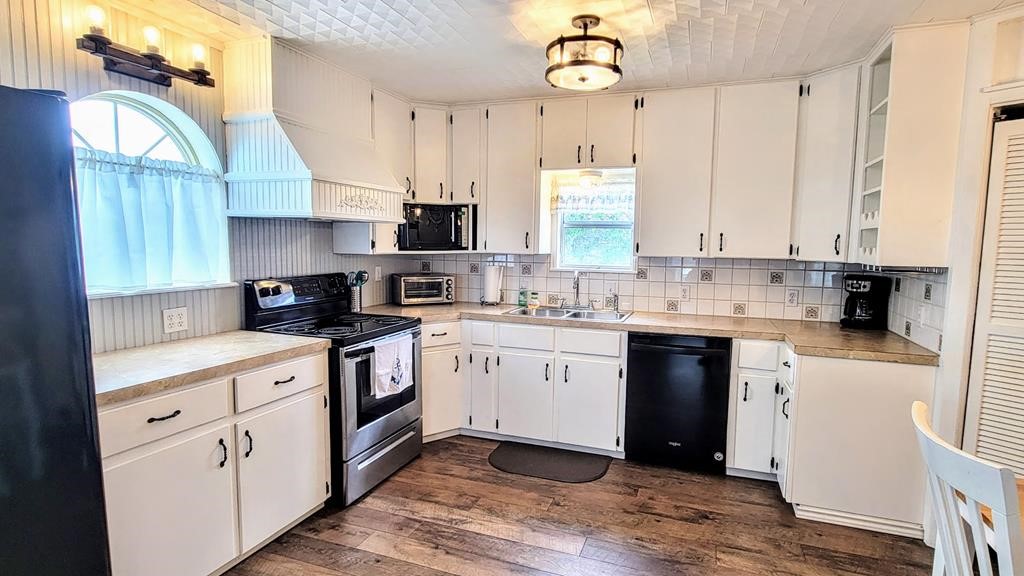 619 Copano Cove Road Rockport, TX 78382 - Photo 8 of 32 a kitchen with a white cabinets and window