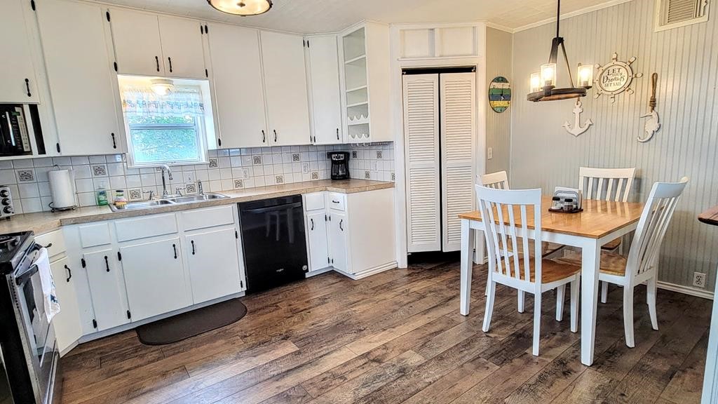 619 Copano Cove Road Rockport, TX 78382 - Photo 9 of 32 a kitchen with a sink cabinets and wooden floor