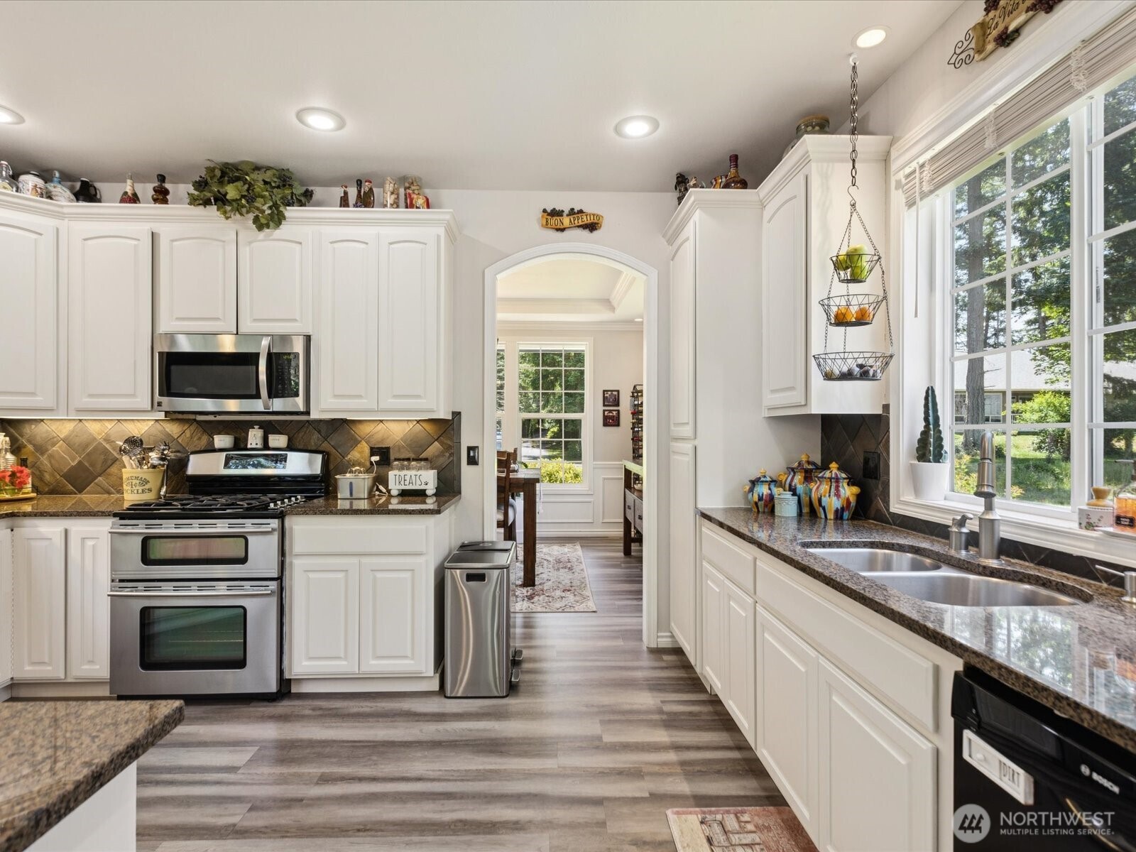 8817 Lakewood Road Stanwood, WA 98292 - Photo 11 of 40 a kitchen with stainless steel appliances kitchen island granite countertop a stove and a sink