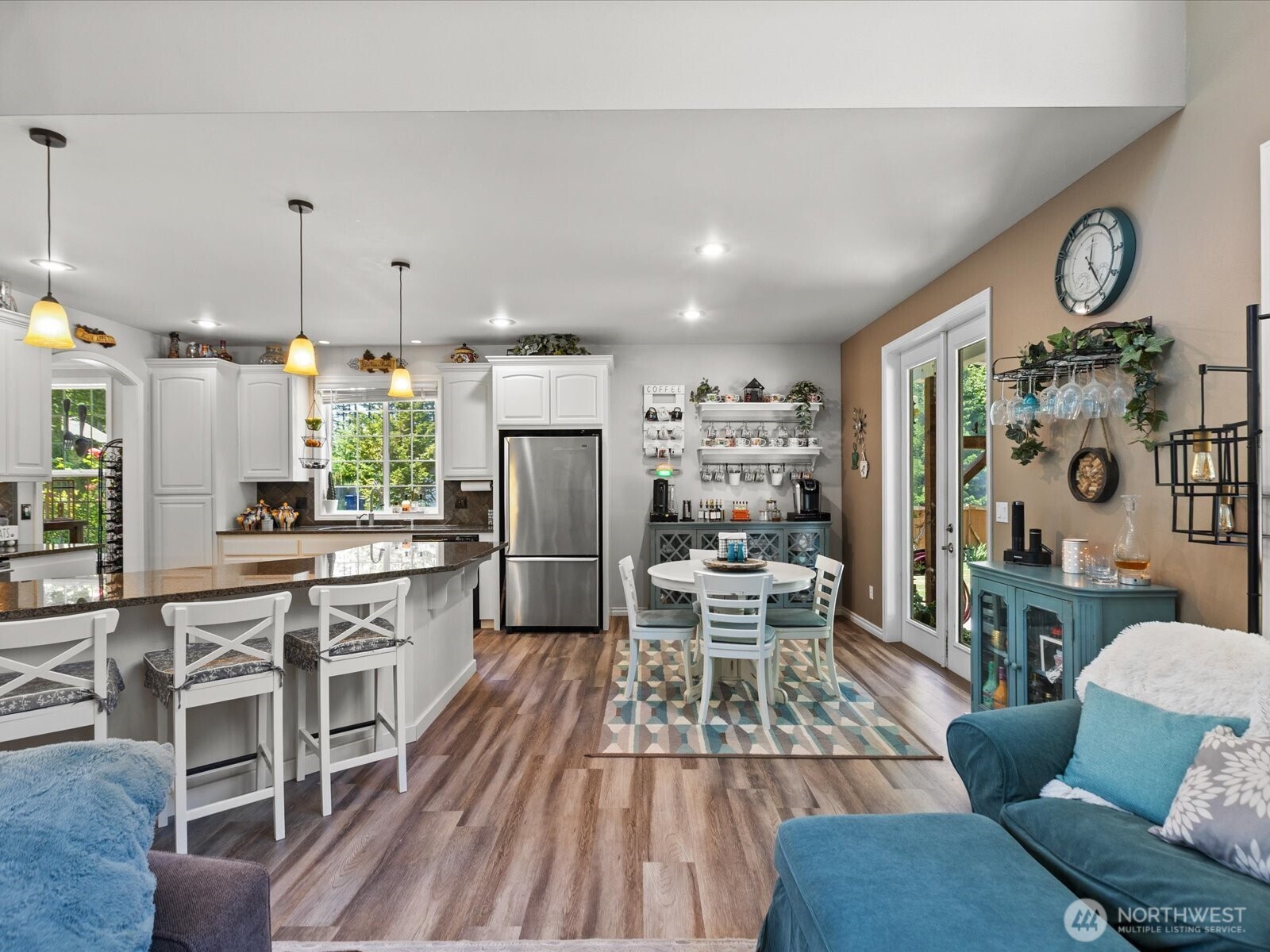 8817 Lakewood Road Stanwood, WA 98292 - Photo 14 of 40 a kitchen with stainless steel appliances a dining table chairs and a refrigerator