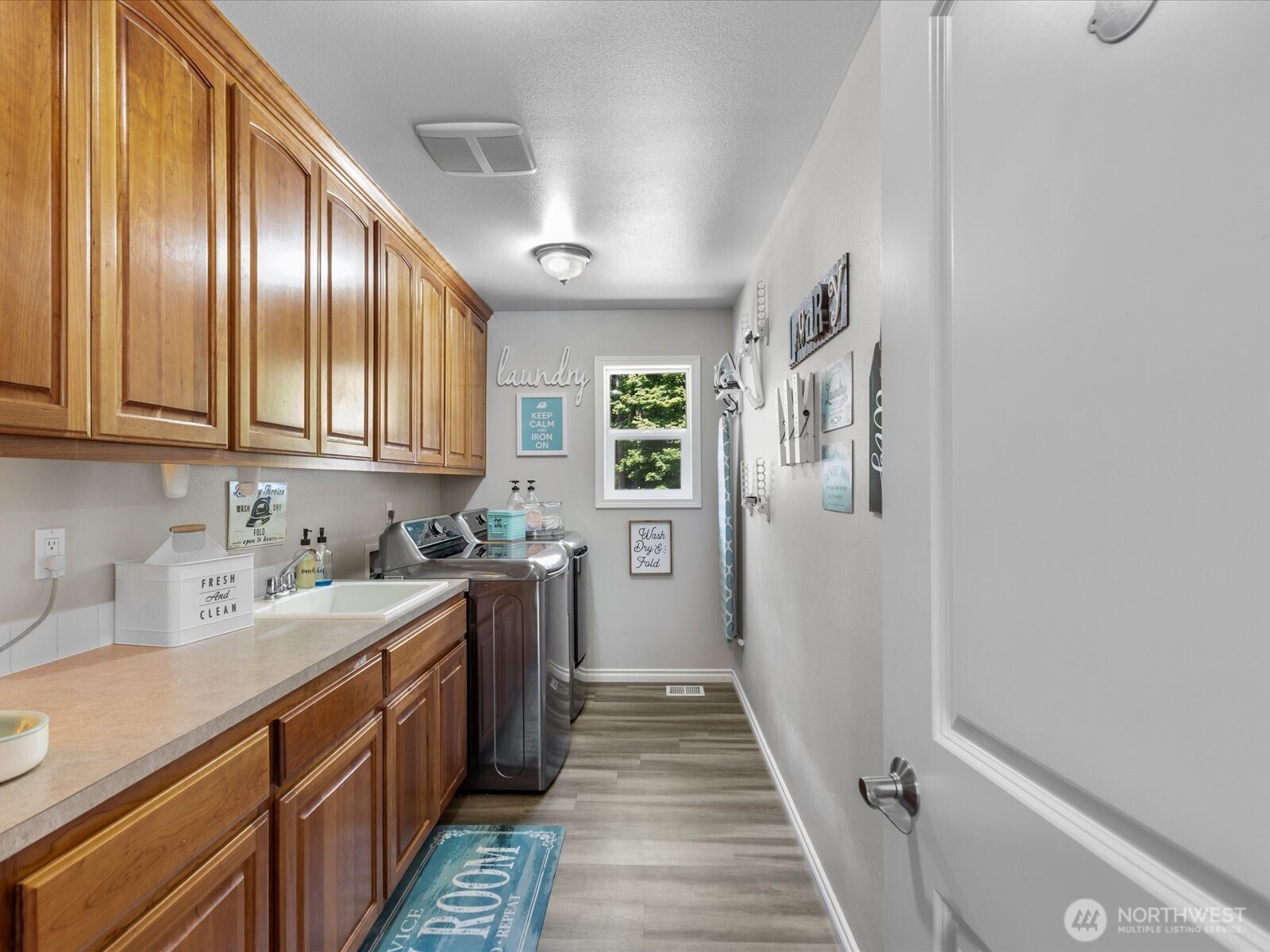 8817 Lakewood Road Stanwood, WA 98292 - Photo 34 of 40 a kitchen with a sink stove and cabinets
