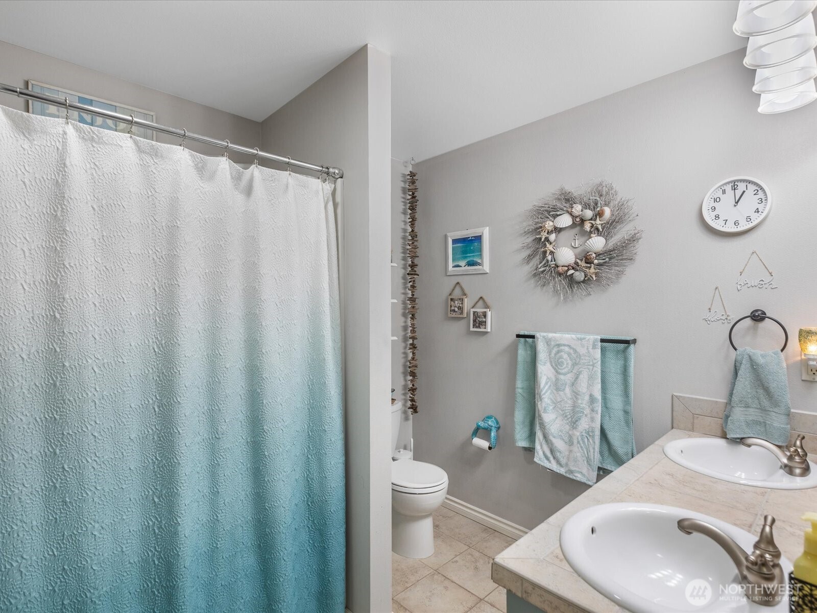 8817 Lakewood Road Stanwood, WA 98292 - Photo 35 of 40 a bathroom with a sink a toilet and shower curtain