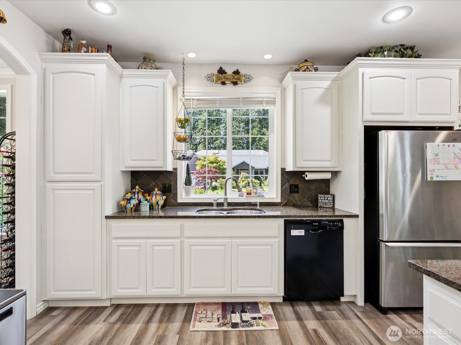 8817 Lakewood Road Stanwood, WA 98292 - Photo 9 of 40 a kitchen with a refrigerator and white cabinets