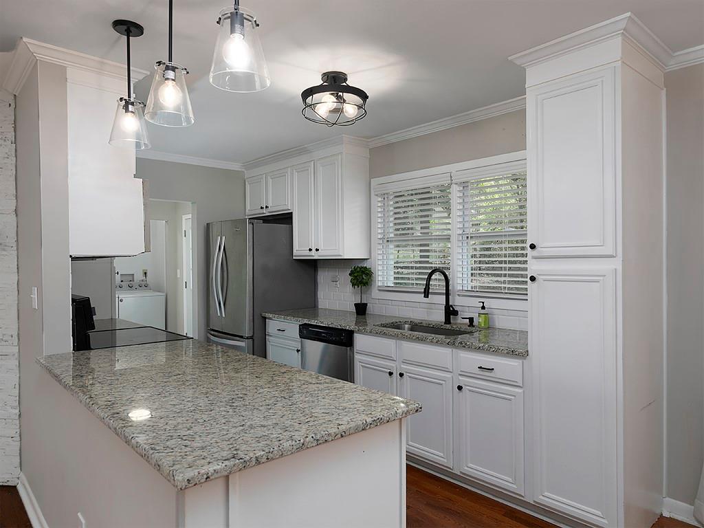 3249 Howell Drive Smyrna, GA 30080 - Photo 11 of 26 a kitchen with stainless steel appliances granite countertop a sink refrigerator stove and microwave