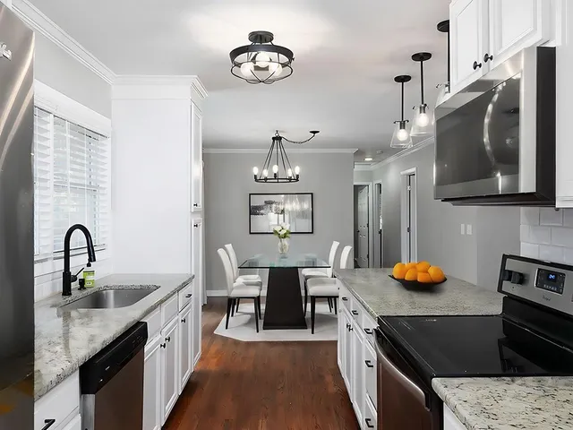 a kitchen with stainless steel appliances granite countertop a sink stove and cabinets