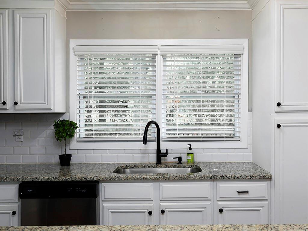 3249 Howell Drive Smyrna, GA 30080 - Photo 13 of 26 a kitchen with granite countertop white cabinets and a window