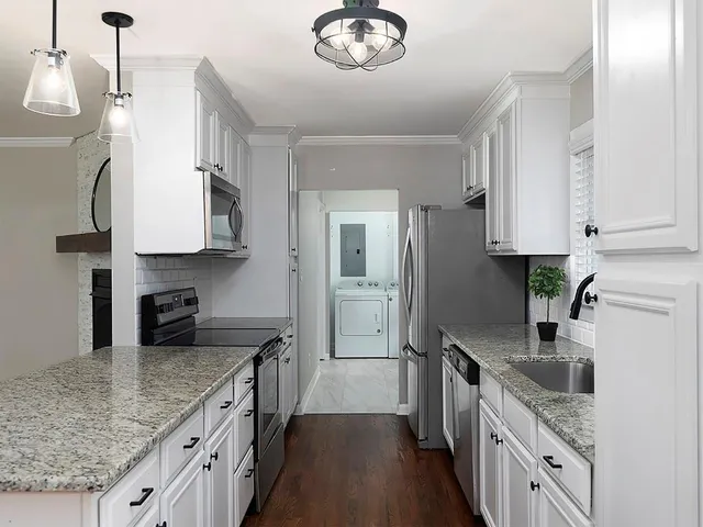 a kitchen with stainless steel appliances granite countertop a sink stove and refrigerator