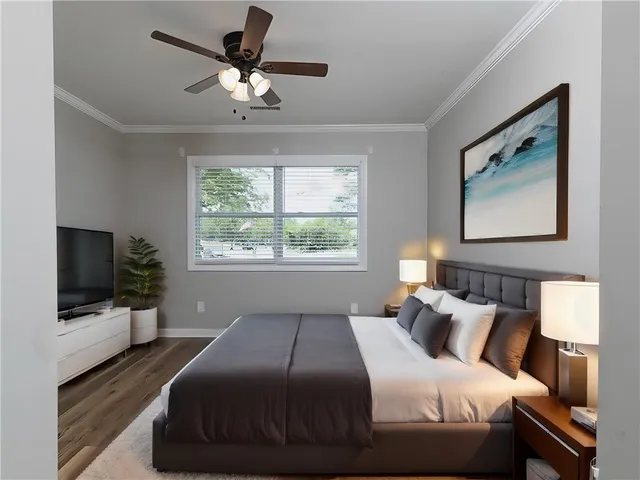 a bedroom with a bed tv and window