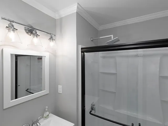 a bathroom with a shower and a mirror