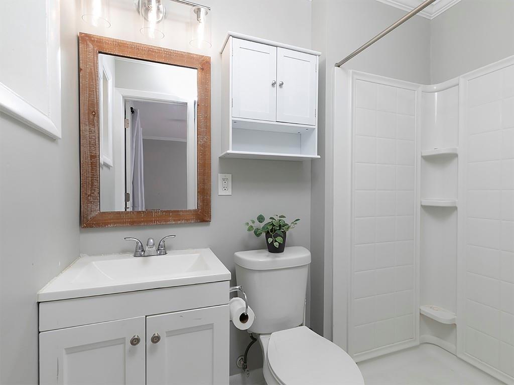 3249 Howell Drive Smyrna, GA 30080 - Photo 19 of 26 a bathroom with a sink a toilet and shower