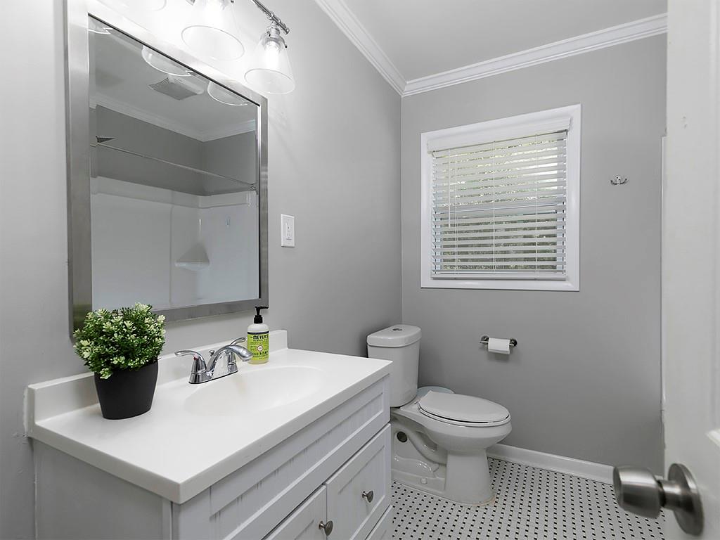 3249 Howell Drive Smyrna, GA 30080 - Photo 22 of 26 a bathroom with a sink a toilet and a mirror