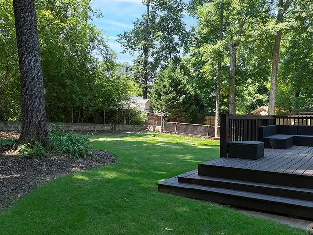 a view of a garden with wooden fence