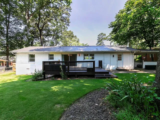 a view of a house with a yard and sitting area