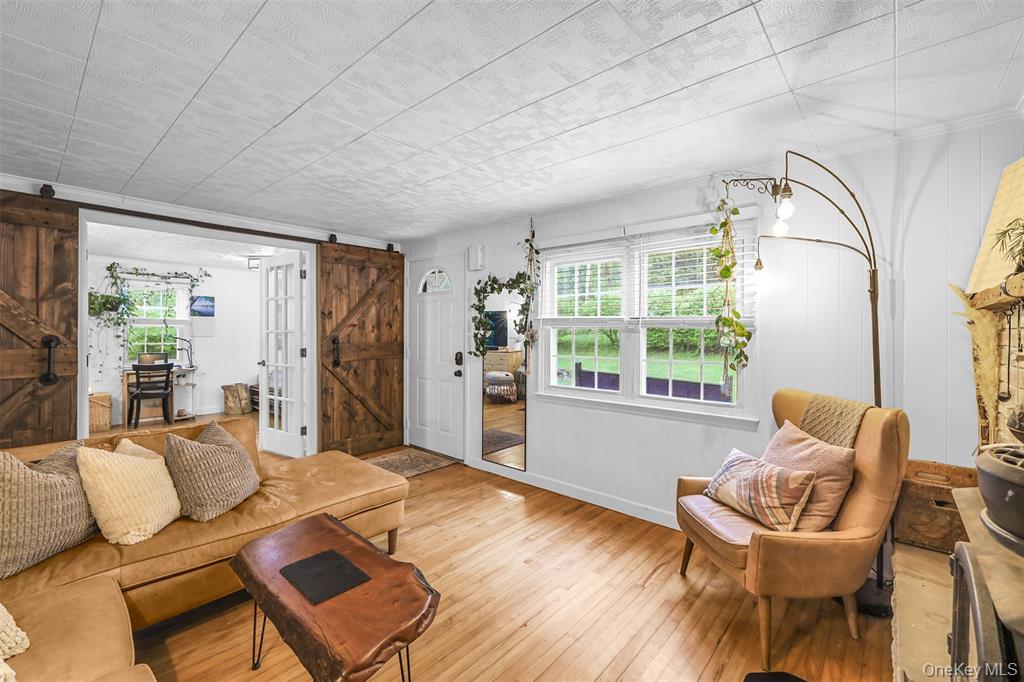46 Quaker Hill Road Monroe, NY 10950 - Photo 13 of 33 Living area with plenty of natural light, a barn door, and hardwood / wood-style flooring