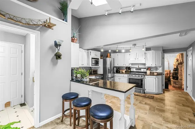 a kitchen with refrigerator and stove