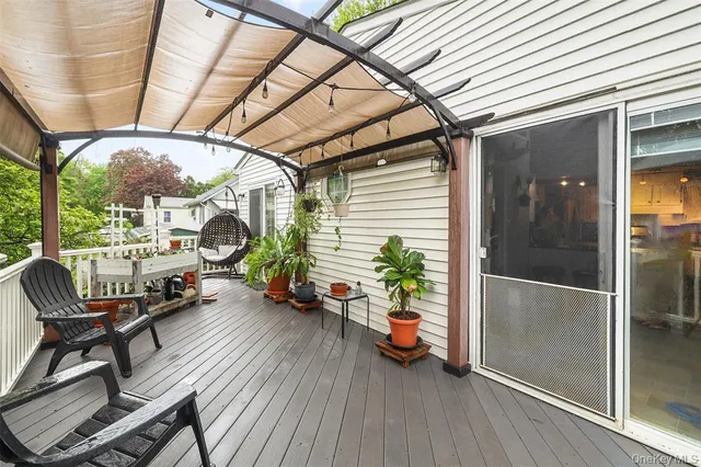 a view of a porch with chairs and potted plants