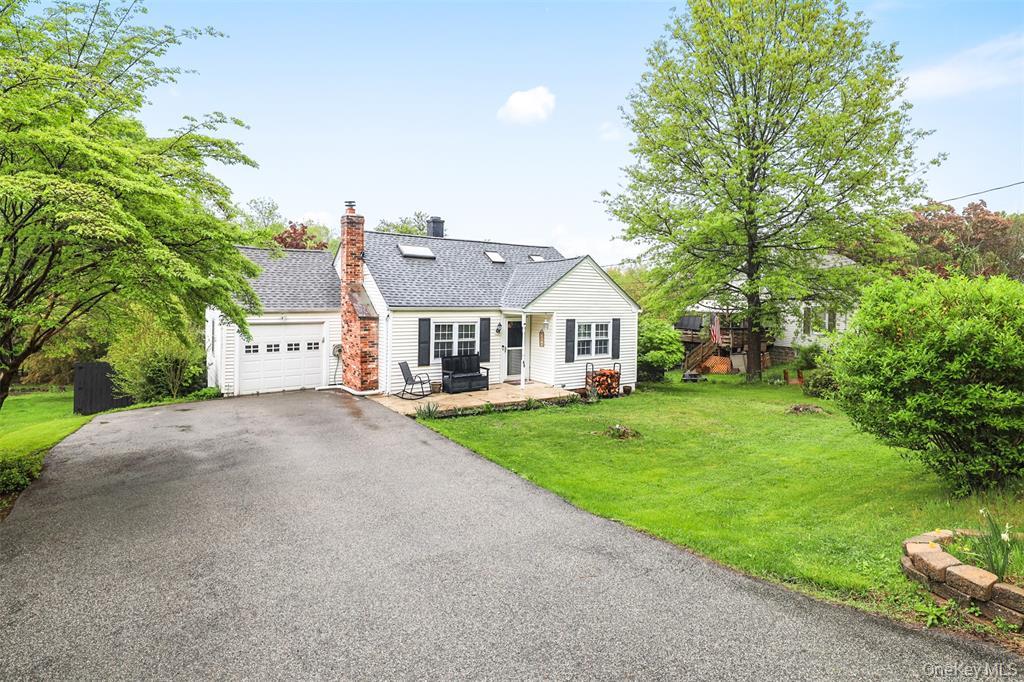 46 Quaker Hill Road Monroe, NY 10950 - Photo 2 of 33 View of front facade featuring a patio, asphalt driveway, a garage, a front lawn, and a chimney