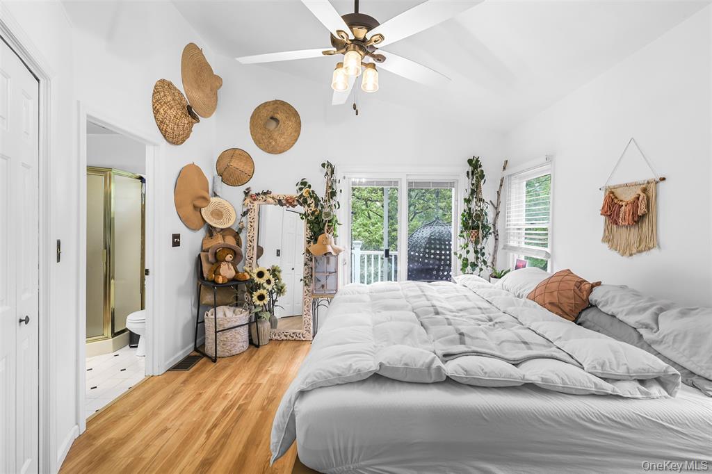 46 Quaker Hill Road Monroe, NY 10950 - Photo 22 of 33 Bedroom with light wood-type flooring, access to outside, vaulted ceiling, a ceiling fan, and ensuite bath